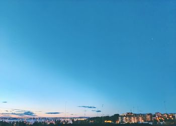 High angle view of buildings against clear blue sky