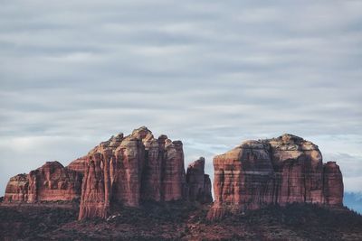 Rock formations on landscape against sky