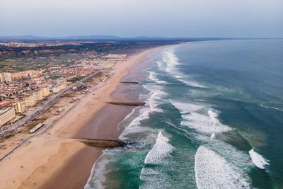 Aerial view of costa da caparica landscape at sunset, view of the majestic beach, setubal, portugal.