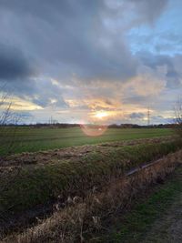 Scenic view of field against sky during sunset