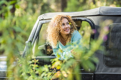 Portrait of young woman in car