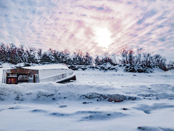 Snow covered landscape against sky