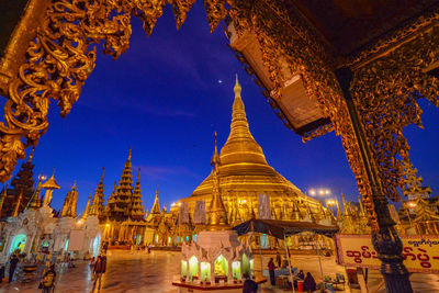 Group of people in temple against building at night