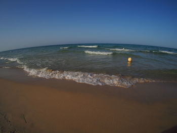 Scenic view of sea against clear blue sky