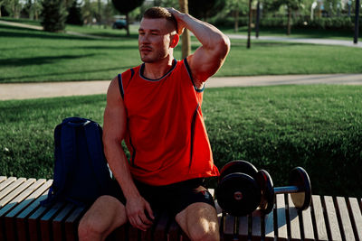 Side view of young man exercising at park