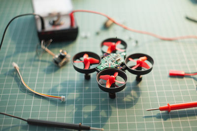 High angle view of incomplete drone model with tools on table