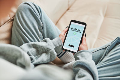 Booking vacation online. person paying for hotel from home. booking flight using mobile payment