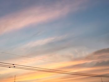 Low angle view of electricity pylon against sky