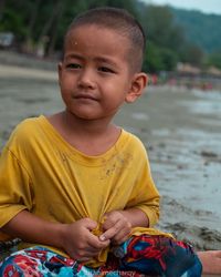 Portrait of boy sitting outdoors