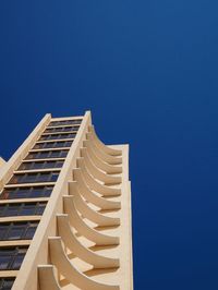 Low angle view of modern building against clear blue sky