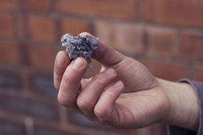 Close-up of hand holding small food