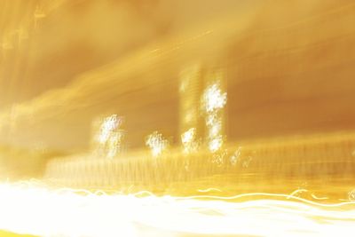 Close-up of illuminated light trails against sky at night