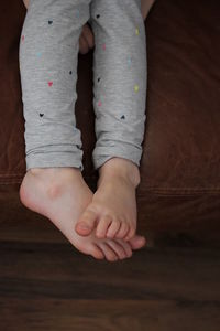 Low section of girl relaxing on floorboard