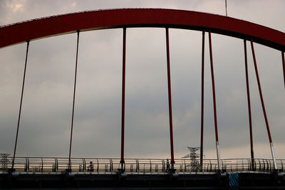 Low angle view of suspension bridge against sky