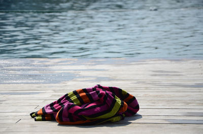 High angle view of towel on pier over lake