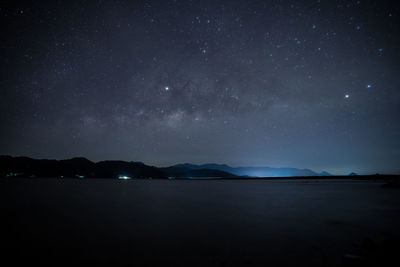 Scenic view of lake against star field at night