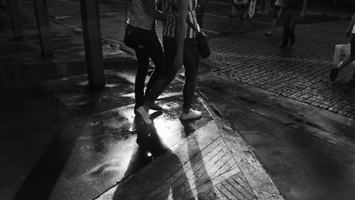 Low section of woman walking on zebra crossing