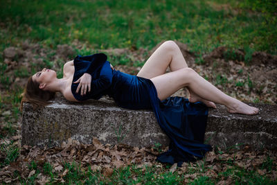 Young woman lying on land