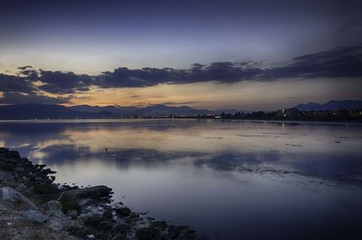 Scenic view of lake against sky at sunset