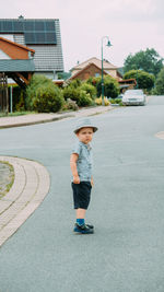 Full length of young woman walking on road