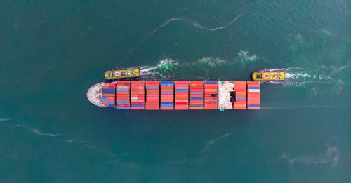 Aerial view of container ship sailing in sea