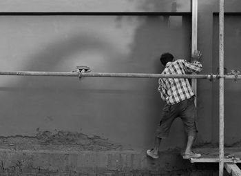 Rear view of construction worker working at site