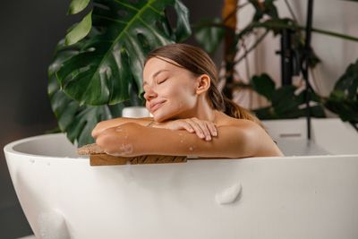 Portrait of young woman in bathtub