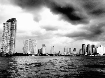 Buildings against cloudy sky