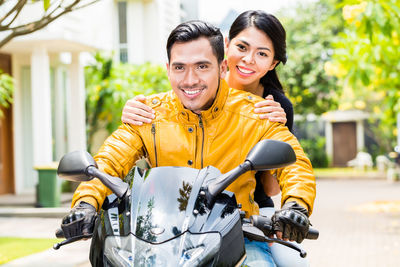 Portrait of smiling young couple in city