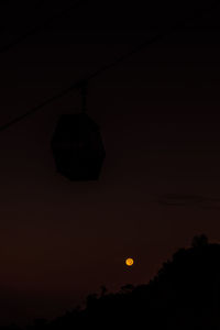 Silhouette trees against sky at night