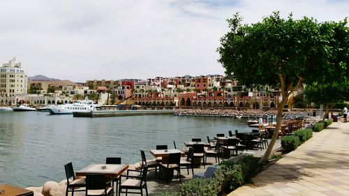 Scenic view of sea against sky in city