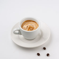 High angle view of coffee cup on white background