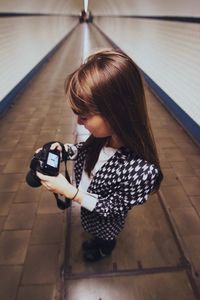 Full length of woman standing by railing