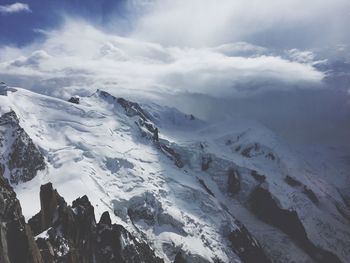 Scenic view of snow covered mountains against sky