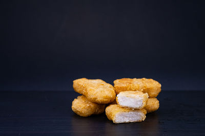 Close-up of cookies on table against black background