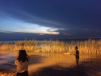 Rear view of woman standing on beach