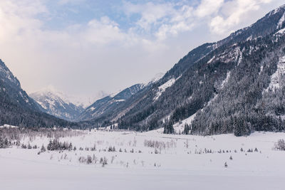 Scenic view of snowcapped mountains valley against sky. austrian apls in winter.