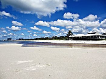 Scenic view of beach against cloudy sky