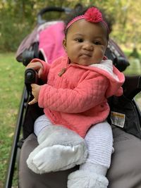 Portrait of cute girl sitting outdoors