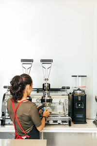 Rear view of woman working on table