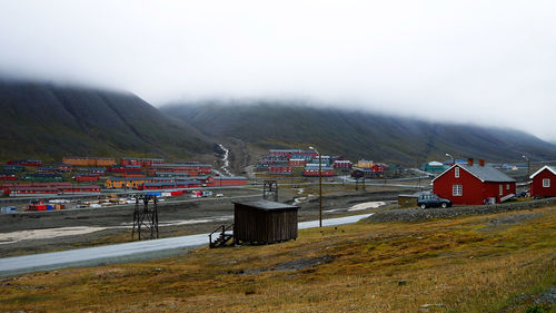 Houses and buildings on mountain against sky