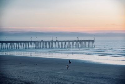 Scenic view of beach against sky during sunset