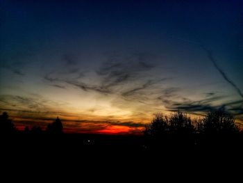 Silhouette trees against sky during sunset