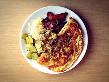 High angle view of omelet and meat served in plate