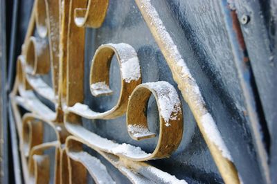 Close-up of snow on metallic fence