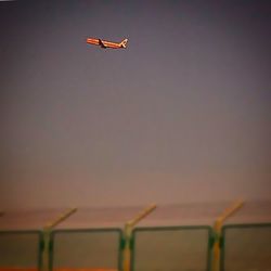 Silhouette of airplane flying in sky