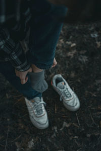 Low section of man standing on field