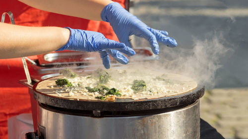 Demonstration cooking, chef making pancakes at naplavka street food market.