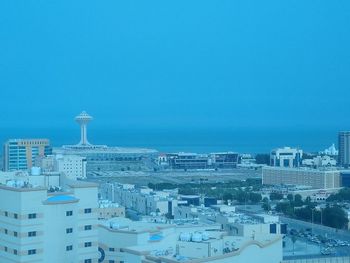 High angle view of buildings against blue sky