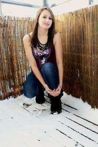 Portrait of a beautiful young woman sitting outdoors